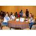 Various individuals sitting at a dinner table.