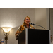 A woman standing behind a podium.