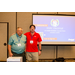 Two men standing by a projector screen giving a presentation.