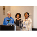 Three individuals standing by a podium.