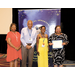 Four people standing next to each other while one holds an award.