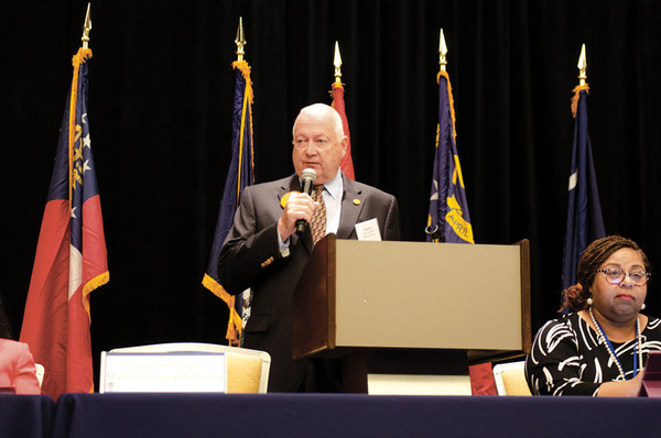 A man standing by a podium.