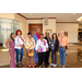 A group of individuals posing in a big lobby for a photo.