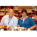 Two individuals posing at one of the dinner tables.