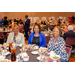 Three women enjoying their meals in the dining hall.