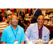 Two men at dinner while smiling for the camera.