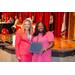 A woman posing with her award with another woman.