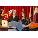 Two women posing while each holding two awards.