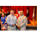 President Anthony and another gentleman smiling big while holding a glass award.