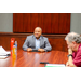 President Anthony Goodson, Jr. sitting at the head of the table while listening to someone speak out of frame.