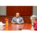 President Anthony Goodson, Jr. smiling and laughing while sitting at the head of the table.