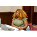 A woman listening avidly to a speaker.