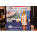 A woman and her booth for SACS Software: Advancing the housing industry since 1969.