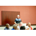 A man speaking to the room while at the podium.