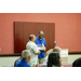 President Anthony Goodson, Jr. smiling and laughing with an individual while standing at the podium together.