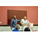 Treasurer James Cox patting President Anthony Goodson, Jr. on the shoulder while they stand behind the podium.