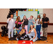 Eight individuals posing with peace signs in the Housingopoly game board photo booth.