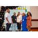 Five people taking a group photo with the Housingopoly game board backdrop.