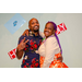 A couple posing with the Housingopoly game board backdrop.