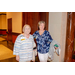 Two woman walking down a hallway smiling for the camera.