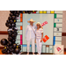 Two woman with big hats posing in the Housingopoly game board photo booth.