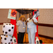 A woman bailing another woman out of the Housingopoly jail photo booth with a hundred dollars in Housingopoly money.