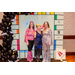 Two women in 70s fashion and a woman in a 20s flapper dress posing for a group photo in the Housingopoly game board photo booth.