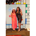 Two women holding up peace signs in the Housingopoly game board photo booth.