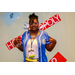 A woman holding up two peace signs with the Housingopoly game board in the background.