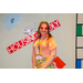 A woman in 70s fashion posing with the Housingopoly game board in the background.