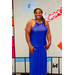 A woman in a long blue dress inside the Housingopoly game board photo booth.