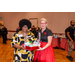 Two women holding a gift basket between them.