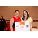 Two women with a poster board that says Pigeon Forge Tennessee Get Away.