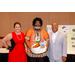 President Anthony Goodson, Jr. taking a photo with two other individuals. One of the individuals holding a gift basket.