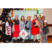 Seven individuals taking a group photo with the Housingopoly game board photo booth.