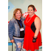 Two individuals in costume posing in the Housingopoly game board photo booth.