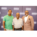 Treasurer James Cox taking a group photo with two other men in front of a Greensboro Housing Authority backdrop.