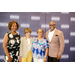 Treasure James Cox posing with three women in front of the Greensboro Housing Authority backdrop.