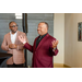 President Anthony Goodson, Jr. speaking and gesturing with his hands to a group of individuals while standing next to Treasurer James Cox.