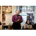 President Anthony Goodson, Jr. in the front of the room listening and smiling as someone off camera speaks.