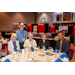 Five people sitting and standing next to the buffet table.