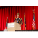 A women speaking to the crowd from behind a podium.