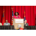 A lady speaking behind the podium on stage.