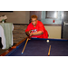 A woman lining up her shot at the pool table.