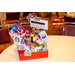 A side view of a red gift basket with several gift cards to various companies.