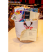 A tall white rope gift basket with various gift cards sticking out of the top of it.