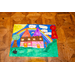 A What Home Means to Me Poster with a second place ribbon. The poster depicts two houses next to each other with a cross beside them and a rainbow going behind the house.