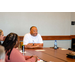 President Anthony Goodson, Jr. smiling while listening to others speak.