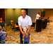 Anthony Goodson, Jr. standing with a child in front of him.