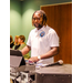 A gentleman standing behind a sound system.